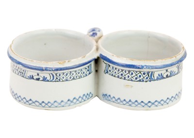 Lot 422 - A painted Delft double cruet holder.