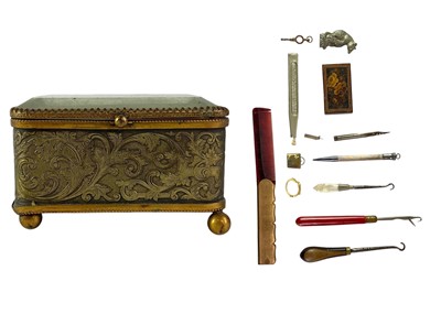 Lot 86 - A collection of curiosities, contained in a French glass topped brass casket.