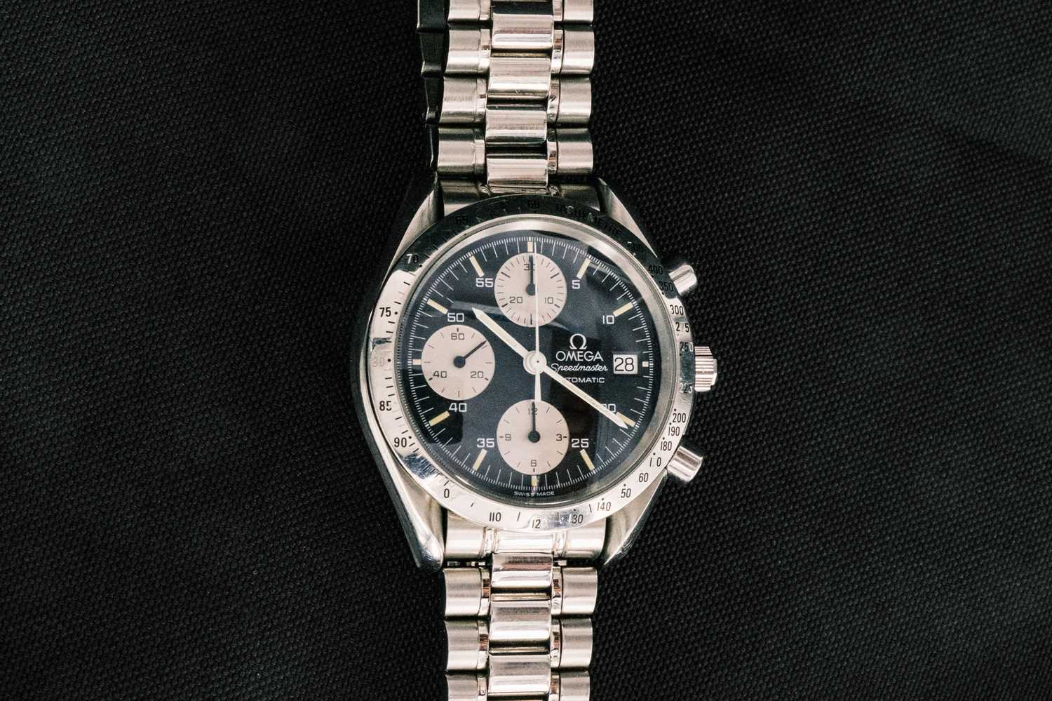 Lot 101 - OMEGA - A Speedmaster Automatic chronograph stainless steel bracelet wristwatch.