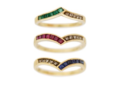 Lot 31 - A set of three diamond, emerald ruby and sapphire set wishbone rings, 18ct set.