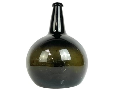 Lot 99 - A large free blown green glass onion wine bottle.