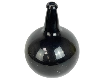 Lot 61 - A large free blown green glass onion wine bottle.