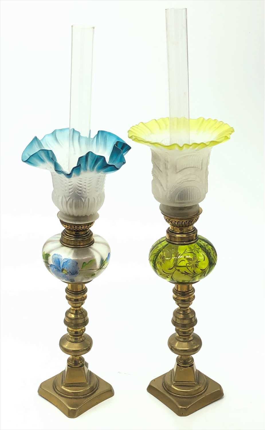 Lot 34 - Two glass and brass oil lamps, surmounted on a...