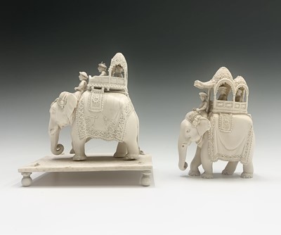 Lot 1069 - Two Indian carved ivory figures of elephants,...