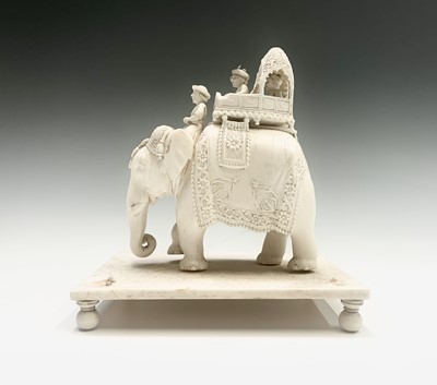 Lot 1069 - Two Indian carved ivory figures of elephants,...