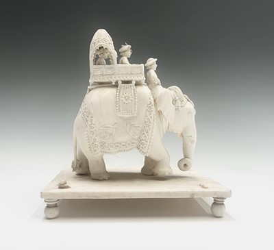 Lot 1069 - Two Indian carved ivory figures of elephants,...