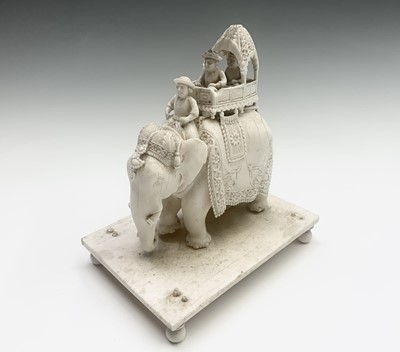 Lot 1069 - Two Indian carved ivory figures of elephants,...