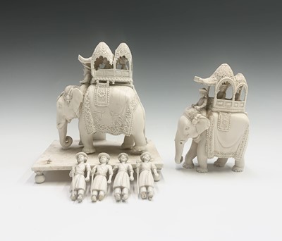 Lot 1069 - Two Indian carved ivory figures of elephants,...