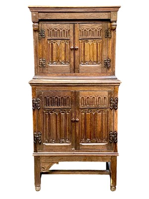 Lot 870 - A small linen fold oak cupboard.