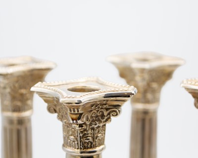 Lot 44 - A good set of four George V Corinthian column candlesticks by John Price Hunt.