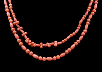 Lot 61 - An Opera length coral bead necklace.