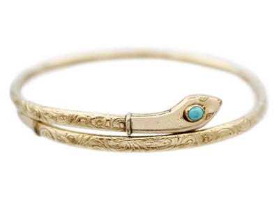 Lot 64 - A Victorian gold-plated turquoise set snake bangle.