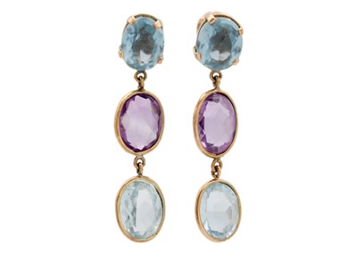 Lot 73 - A pair of amethyst and blue topaz set gold mounted (tests 14ct) pendant earrings.