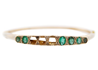 Lot 79 - An Edwardian 9ct green paste and diamond point set hinged bangle.