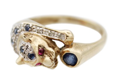 Lot 80 - A 9ct leopard design ring set with diamonds, sapphires and cabochon ruby eyes.