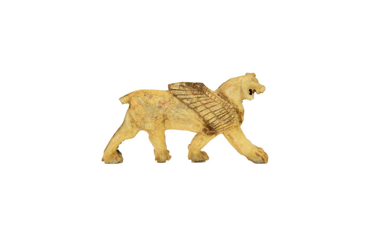Lot 1062 - A Phoenician bone plaque of a winged lion.