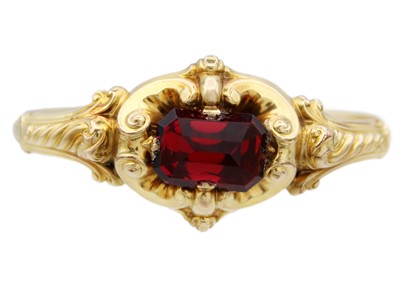 Lot 83 - A Victorian high-purity gold (tests 14ct) bangle with large red paste stone.