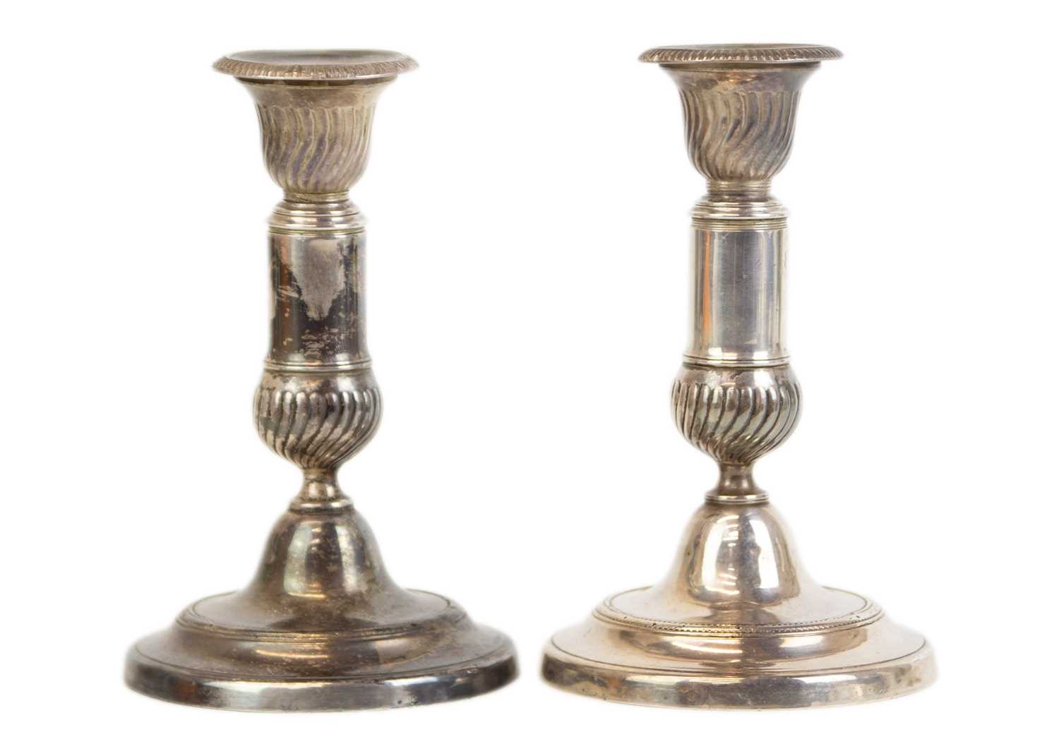 Lot 62 - A pair of late George III white metal telescopic candlesticks