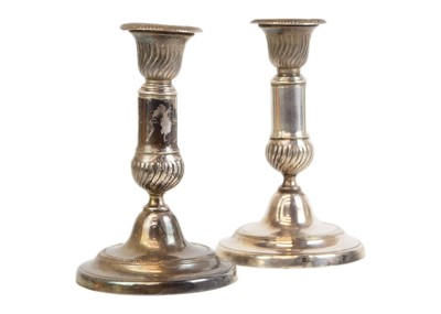 Lot 62 - A pair of late George III white metal telescopic candlesticks