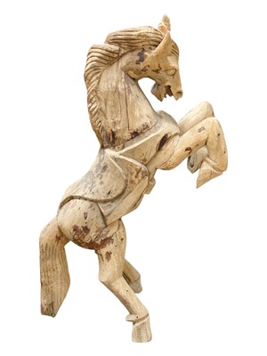 Lot 600 - A carved hardwood figure of a rearing horse.