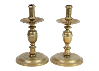 Lot 1178 - A matched pair of late 17th century continental brass candlesticks.