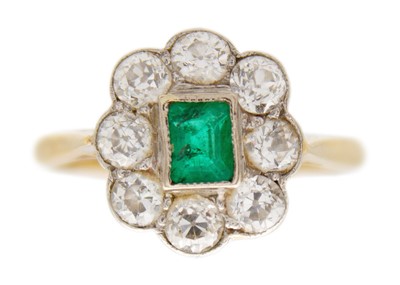 Lot 181 - An attractive 18ct emerald and diamond set cluster ring.