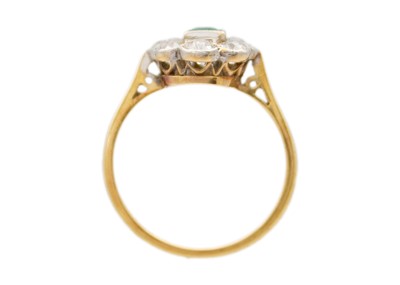 Lot 181 - An attractive 18ct emerald and diamond set cluster ring.