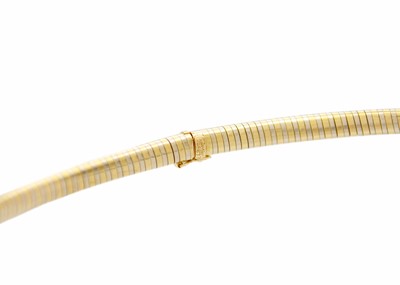 Lot 49 - CARTIER - An 18ct bi-colour omega collar.