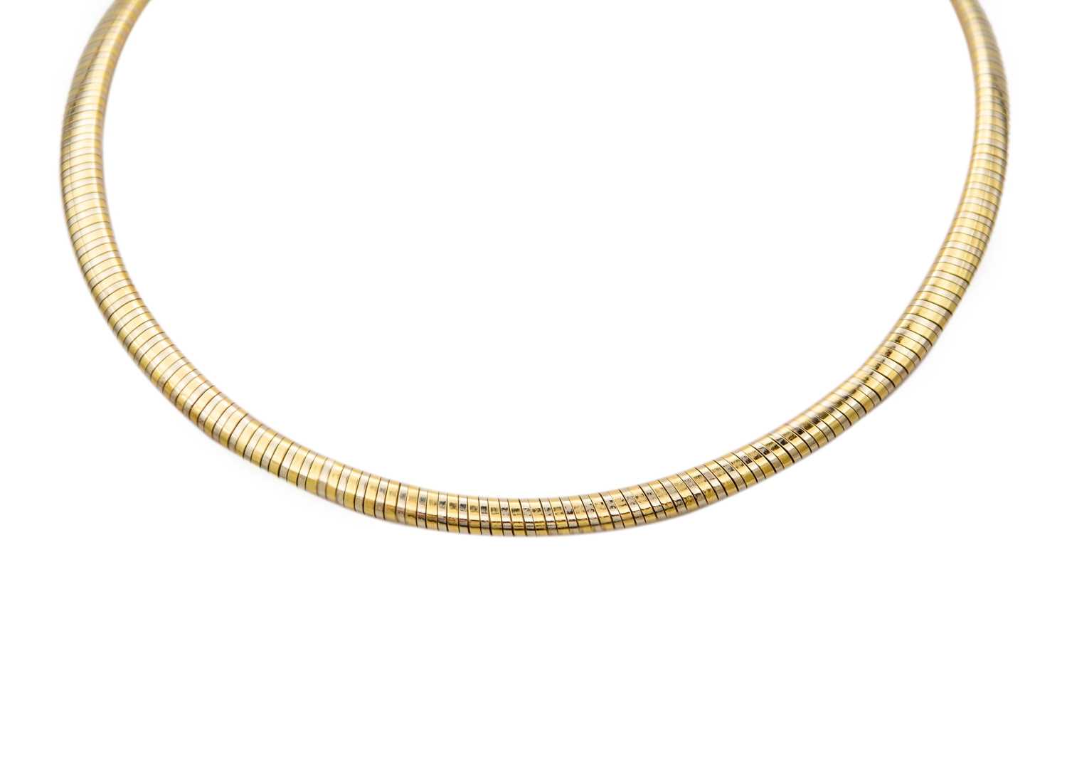 Lot 49 - CARTIER - An 18ct bi-colour omega collar.