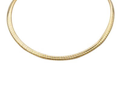 Lot 49 - CARTIER - An 18ct bi-colour omega collar.