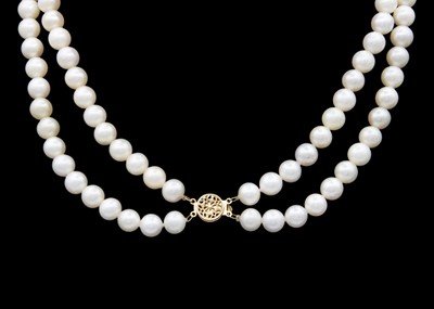 Lot 151 - A cultured white pearl double-strand necklace with a 14k clasp.