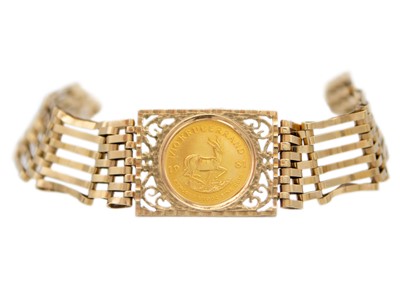 Lot 91 - A 9ct six bar gate link bracelet with 1/10 Krugerrand coin.