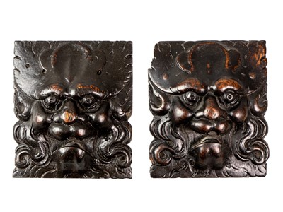 Lot 1032 - A pair of carved oak Green Man masks.