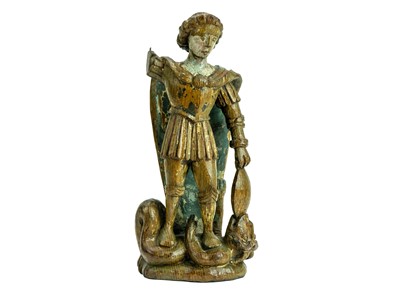 Lot 1103 - A carved oak figure of St Michael vanquishing Satan.