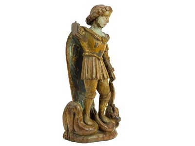Lot 1103 - A carved oak figure of St Michael vanquishing Satan.