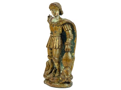 Lot 1103 - A carved oak figure of St Michael vanquishing Satan.