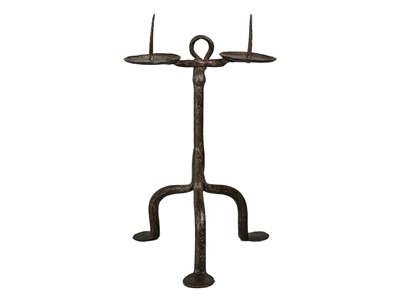 Lot 1007 - An English wrought iron double pricket candlestick.