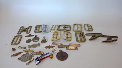 Lot 64 - Brass buckles and other metal badges, some...