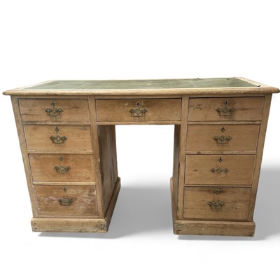 Lot 37 - A nine-drawer stripped pine desk with a green...