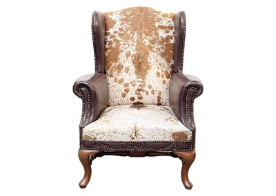 Lot 668 - A George II style mahogany framed wingback armchair.