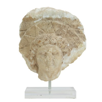 Lot A Roman marble head of Helios.