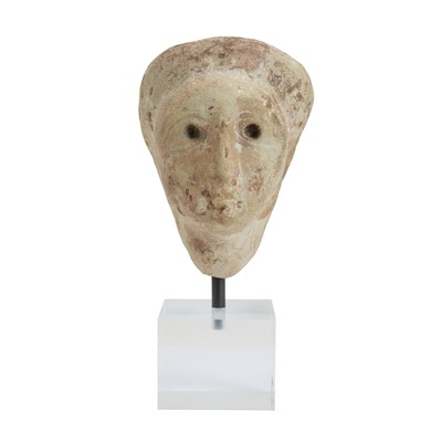 Lot 1108 - A carved stone female head.