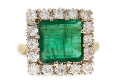 Lot 190 - An attractive emerald and diamond 18ct set cluster ring.