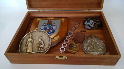 Lot 157 - A wooden box containing plaques and watches,...