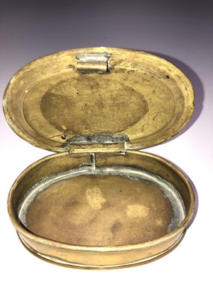 Lot 13 - A brass tobacco box of oval form, inscribed...