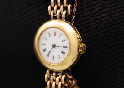 Lot 132 - An early 20th century 18ct cased manual wind lady's watch with 15ct bracelet.