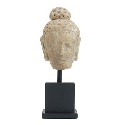 Lot 1079 - A stucco head of a young Buddha.