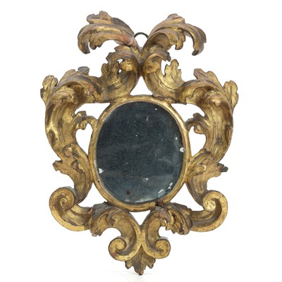 Lot A Florentine small carved giltwood wall mirror.