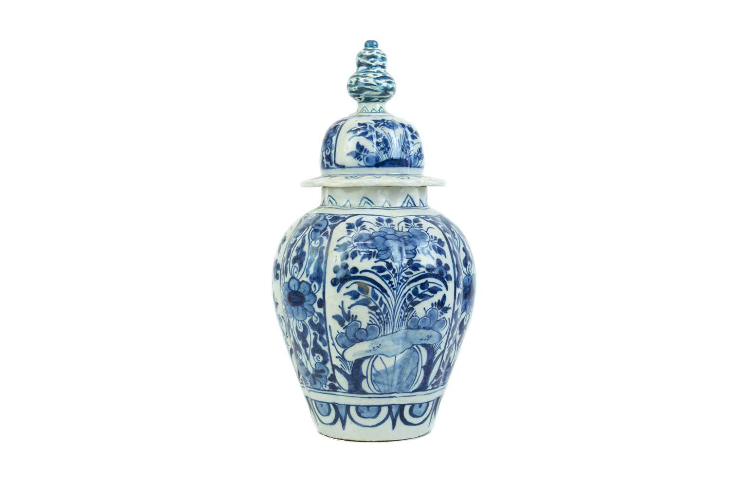 Lot 1133 - A Dutch Delft blue and white baluster vase and cover.