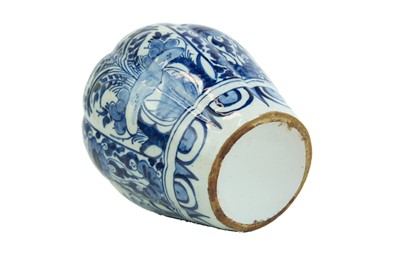 Lot 1133 - A Dutch Delft blue and white baluster vase and cover.